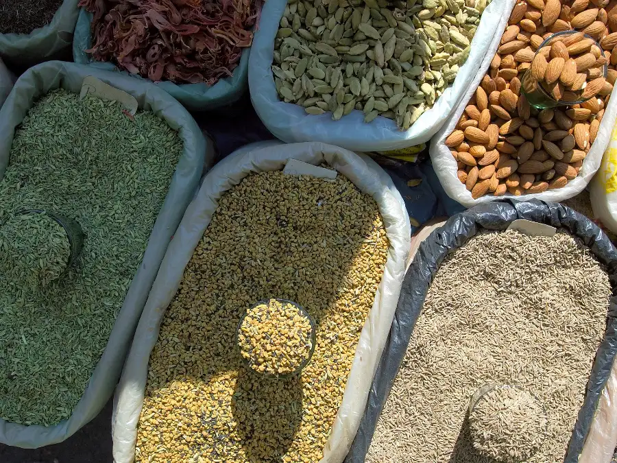 Bowls of Indian spices, herbs and seeds of the kind blended into samama attar