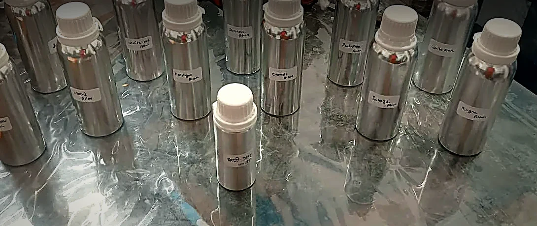 Venus Perfumery attars in bulk — sealed aluminium bottles, labelled by name